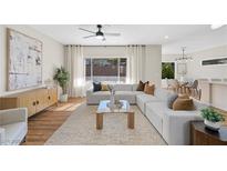 Bright living room featuring a large sofa, natural light, and modern decor for a welcoming space at 2585 Shellsburg Ave, Henderson, NV 89052