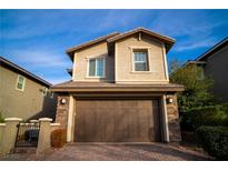 Charming two-story home with stone accents and a two-car garage, complemented by a well-manicured brick driveway at 343 Cadence Vista Dr, Henderson, NV 89011