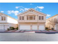 Inviting two-story townhome showcasing multiple garages and well-kept landscaping at 5465 Jackpot Winner Ln # 102, Las Vegas, NV 89122