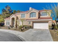 Charming two-story home featuring a tile roof, desert landscaping, and an attached two-car garage at 7624 Nocturne Ct, Las Vegas, NV 89128