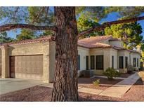 Charming single-story home with a two-car garage, desert landscaping, and a red tile roof at 7900 Shelter Island Way, Las Vegas, NV 89145