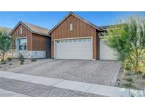 Charming home featuring a two-car garage, brick driveway, and well-maintained landscaping at 829 Stepney Pl, Henderson, NV 89011