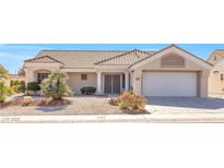 Charming single-story home featuring a well-manicured desert landscape and a two-car garage at 8513 Festival Dr, Las Vegas, NV 89134