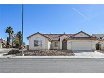 Charming single-story home featuring a well-maintained yard and a two-car garage at 1701 Santa Rosalia Dr, North Las Vegas, NV 89031