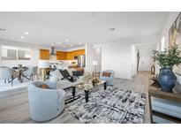 Bright, open-concept living room with modern decor, seamlessly connecting to the kitchen and dining areas at 1722 Game Garden Rd, North Las Vegas, NV 89031