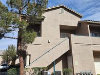 Charming condo featuring two stories with stucco exterior, and a quaint landscaped entrance at 2052 Jade Creek St # 202, Las Vegas, NV 89117