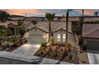 Charming single-story home featuring a tile roof, two-car garage and lush desert landscaping at 2119 Lewiston Pl, Henderson, NV 89044