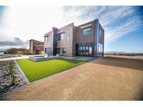 Contemporary two-story home with desert landscaping and unique water feature at 3530 S Spring Mountain Blvd Ct, Pahrump, NV 89048