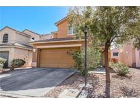Charming two-story home featuring a two-car garage and desert landscaping at 4130 Neighborly Ct, North Las Vegas, NV 89032