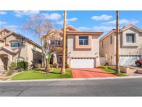 Charming two-story home featuring a well-maintained lawn and a red driveway at 4450 Zev Ct, Las Vegas, NV 89121