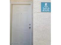 A white door displaying unit number 202, located inside a condo at 5000 Red Rock St # 202, Las Vegas, NV 89118