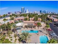 Community pool features beautiful palm trees, city views, and plenty of space to relax at 5080 Indian River Dr # 398, Las Vegas, NV 89103