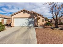 Charming single-story home featuring a well-maintained front yard and a two-car garage in a Gathering-friendly neighborhood at 5128 Canary Island Ct, North Las Vegas, NV 89031