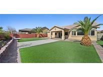 A well maintained backyard boasts a beautiful lawn and desert landscaping at 5573 Wedge Ct, Las Vegas, NV 89122