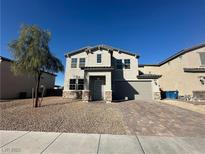 Charming two-story home featuring well-manicured landscaping, a two-car garage, and a welcoming entrance at 5721 Coral Sun St, North Las Vegas, NV 89031