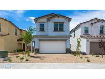 Charming two-story home featuring a two-car garage and desert landscaping at 637 N Water St, Henderson, NV 89015