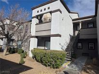 Attractive exterior view of a two-story condo featuring a private balcony and well-maintained landscaping at 7255 W Sunset Rd # 1171, Las Vegas, NV 89113