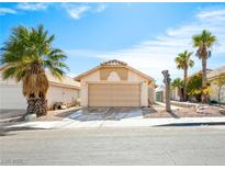 Charming single-story home with a two-car garage and desert landscaping including mature palm trees at , Las Vegas, NV 89107