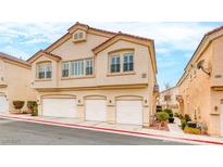 Inviting townhome with private garages in a well-maintained community under a partly cloudy sky at 2589 Velez Valley Way, Henderson, NV 89002