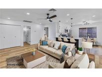 Bright open-concept living room with modern furnishings flows seamlessly into the kitchen, perfect for entertaining at 4385 Bramblewood St, Las Vegas, NV 89147