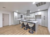 Modern kitchen with a center island, stainless steel appliances, and sleek countertops at 4667 E Boston Ave, Las Vegas, NV 89104