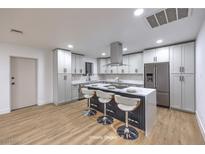 Modern kitchen featuring gray cabinetry, stainless steel appliances, and an island with barstool seating at 4667 E Boston Ave, Las Vegas, NV 89104