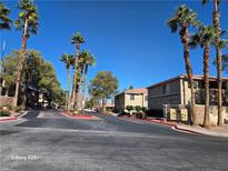 Exterior view of the Marqesa Condominiums community, featuring palm trees and well-maintained landscaping at 7200 Pirates Cove Rd # 1025, Las Vegas, NV 89145