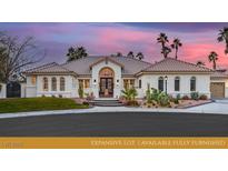 Stunning home featuring lush landscaping, a tile roof, and a custom metal entry gate at 8211 Windsor Crest Ct, Las Vegas, NV 89123