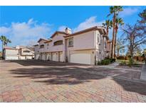 Exterior view of a home with a brick driveway, desert landscaping, and a multi-car garage at 108 Lemon Glaze St # 202, Las Vegas, NV 89145