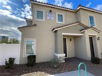 Modern two-story townhome featuring desert landscaping and private entrances at 3669 Canis Minor Ln # 15101, Henderson, NV 89052