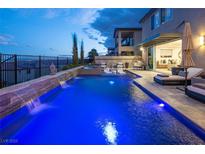 Inviting pool with waterfall feature and cozy lounge area, perfect for relaxing evenings at 4612 Amazing View St, Las Vegas, NV 89129