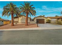Charming single-story home featuring desert landscaping, a two-car garage, and gated courtyard at 6870 Laronda Ln, Las Vegas, NV 89156