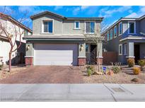 Two-story home featuring an attached two-car garage and desert landscaping at 920 Lotus Falls St, Henderson, NV 89052