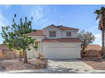 Charming two-story home with stucco siding, a red tile roof, and a two-car garage at 2573 Rafferty Creek Ln, Las Vegas, NV 89156