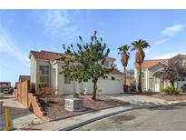 Charming two-story home features a well-maintained yard and desert landscaping at 2573 Rafferty Creek Ln, Las Vegas, NV 89156