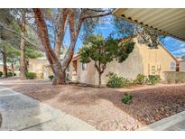Charming condo with well-maintained landscaping, mature trees, and exterior beige stucco at 2851 S Valley View Blvd # 1079, Las Vegas, NV 89102