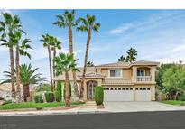 Charming two-story home with desert landscaping, palm trees, and a three-car garage at 3367 Trickling Stream Cir, Las Vegas, NV 89117