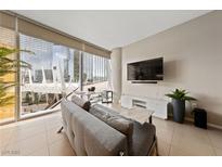 Bright living room features floor-to-ceiling windows and comfortable seating with views of the city at 3726 Las Vegas Blvd # 303, Las Vegas, NV 89158