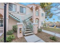 A condo building featuring stucco siding, dual paned windows, and elevated access stairs to the second story units at 4861 S Torrey Pines Dr # 201, Las Vegas, NV 89103