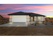 Charming single-story home boasts a well-manicured lawn and inviting curb appeal at 60 E Jaybird St, Pahrump, NV 89048