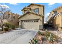 Charming two-story home features an attached two car garage and desert landscaping at 620 Sunderland Ct, Las Vegas, NV 89178