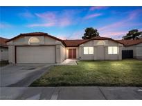 Charming single-story home featuring a well-maintained lawn and a two-car garage at 6413 Chippindale Ln, Las Vegas, NV 89108