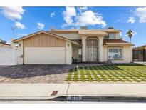 Two-story home featuring brick driveway and a unique lawn pattern at 6775 Segura Dr, Las Vegas, NV 89103