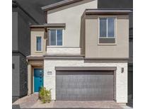 Beautiful two-story home featuring stone accents, a front-entry garage, and a pop of color from the turquoise front door at 11940 Vector Ray Ave, Las Vegas, NV 89138