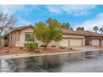 Charming single story home featuring desert landscaping, a tile roof, and a two-car garage at 1433 Erskine Ave, Las Vegas, NV 89123