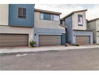 Modern townhouse featuring a two-car garage and contemporary design elements at 2699 Chance Canyon St, Henderson, NV 89044