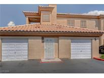 Two-story home featuring a front entrance and two-car garage, offering convenience and curb appeal at 3600 Pierida St # 201, Las Vegas, NV 89108