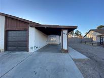 View of the property with a two-car carport and a garage on the left side of the home at 4471 Pinegrove St, Las Vegas, NV 89147