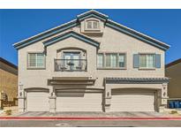 Attractive three-story townhome featuring three garage doors and a small balcony at 4710 Ridgeley Ave # 102, North Las Vegas, NV 89084