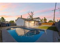 Backyard pool reflecting the house with a covered patio, perfect for outdoor entertaining at 6121 Fairwood Cir, Las Vegas, NV 89107